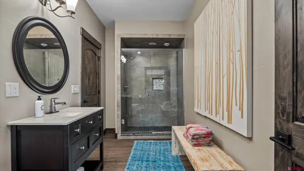 a bathroom with a sink a mirror and a shower