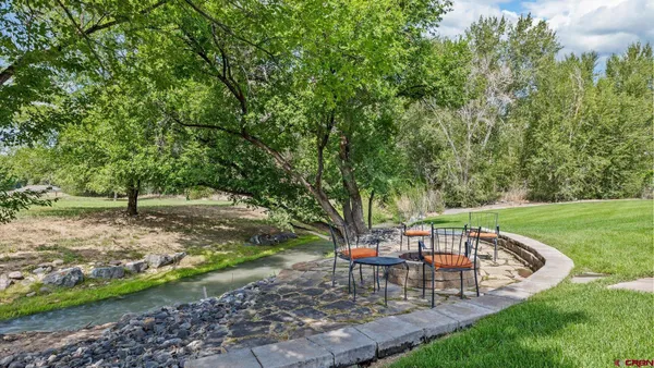a view of a table and chairs in the garden