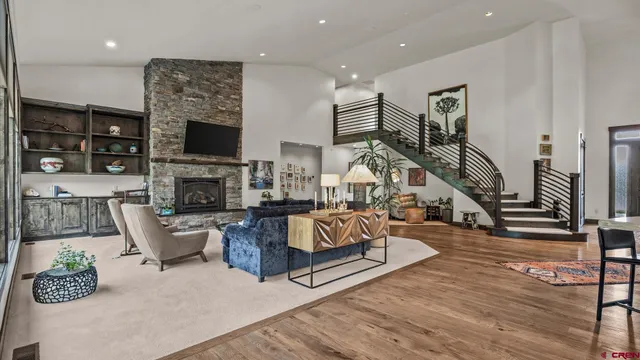a living room with fireplace furniture and a flat screen tv