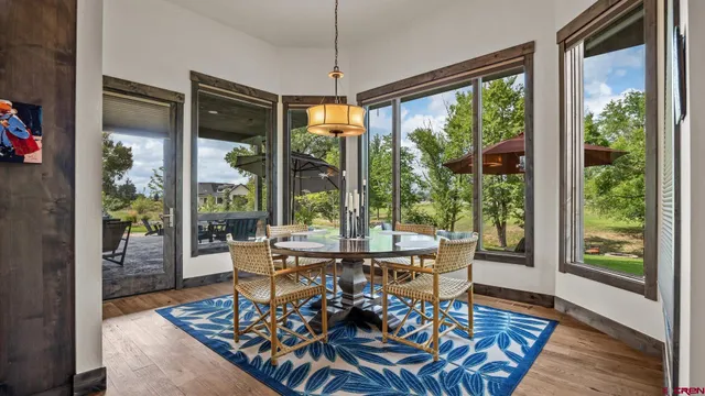 a dining room with furniture wooden floor and a potted plant