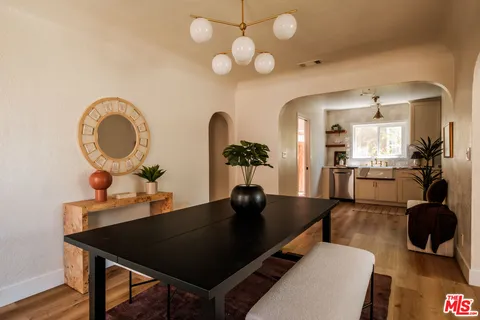 a kitchen with a stove and a white wooden cabinets