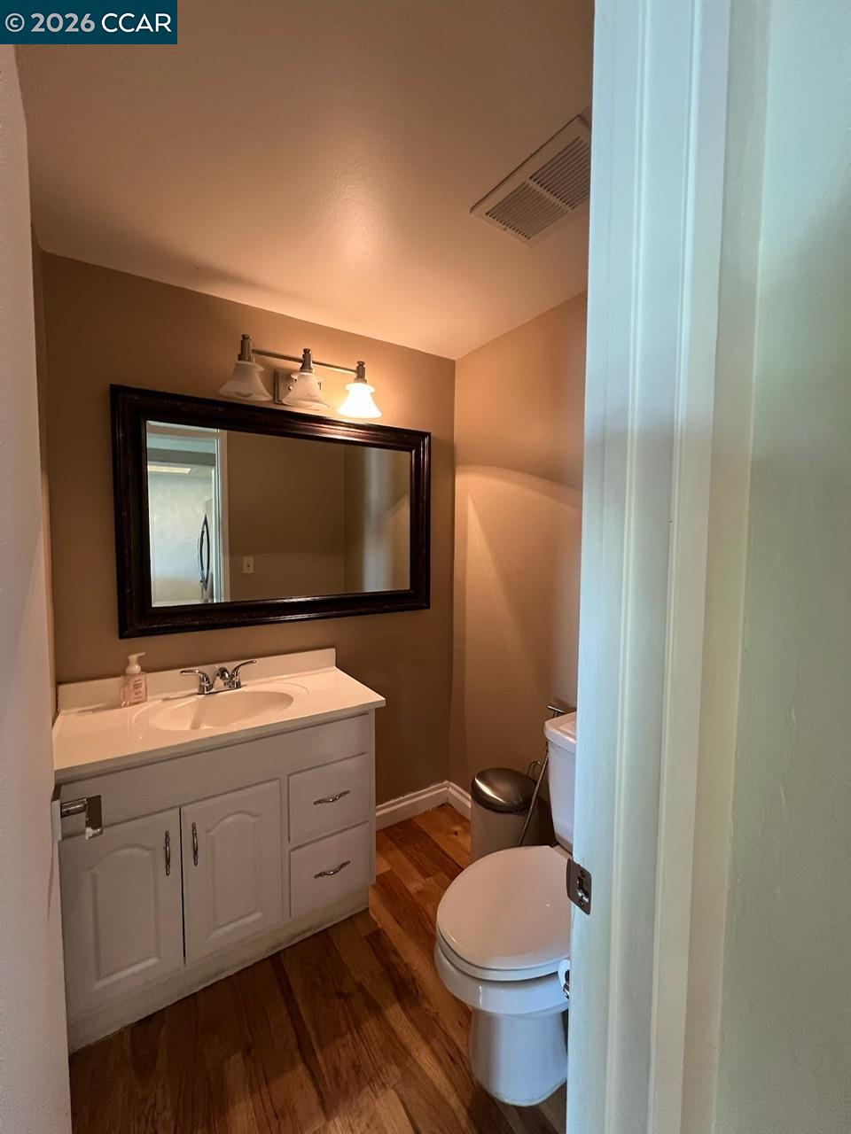 438 Ridgeview Drive Pleasant Hill, CA 94523 - Photo 12 of 12 a bathroom with a toilet sink and mirror