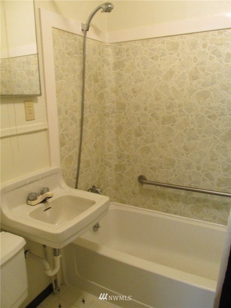 1020 J Street Hoquiam, WA 98550 - Photo 12 of 24 a bathroom with a sink and a mirror