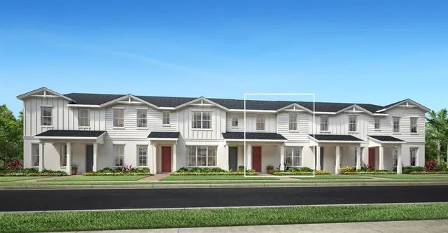 a view of a white house with a yard and plants