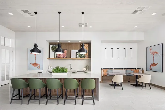 a view of dining room and kitchen with table and chairs