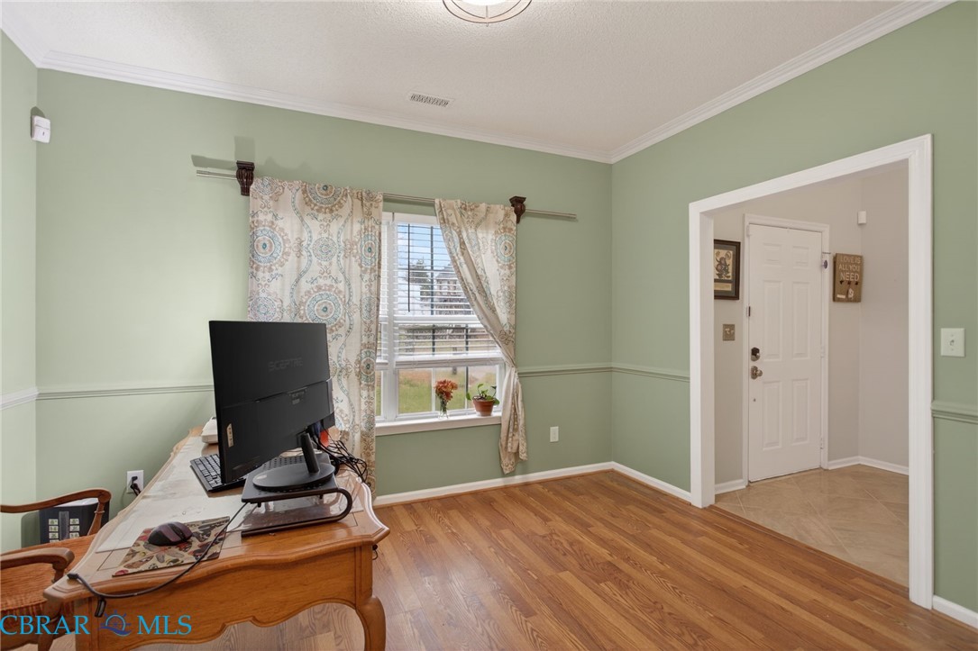 116 Old Field Road Williamsburg, VA 23188 - Photo 17 of 27 Home office featuring light wood-type flooring, ornamental molding, and a textured ceiling
