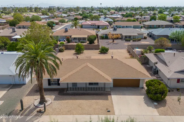 an aerial view of a house with garden space and lake view