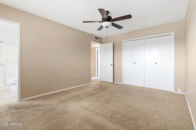 a bathroom with a granite countertop sink a toilet and a shower