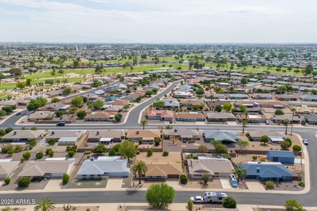 an aerial view of residential building and lake