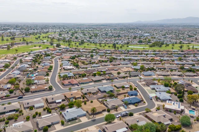 an aerial view of residential houses with outdoor space