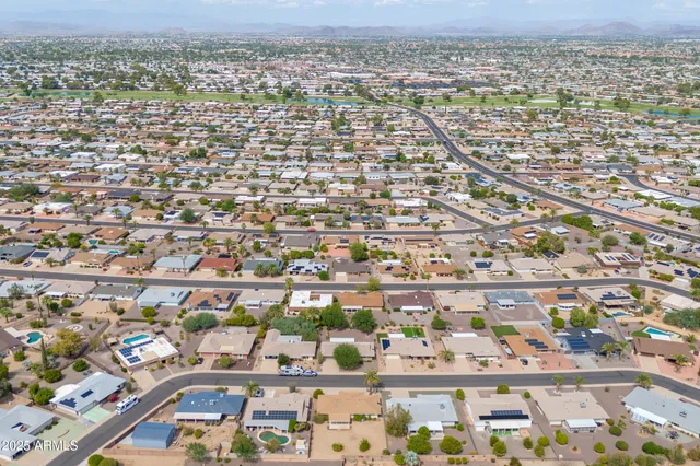 an aerial view of a house with a yard and lake view
