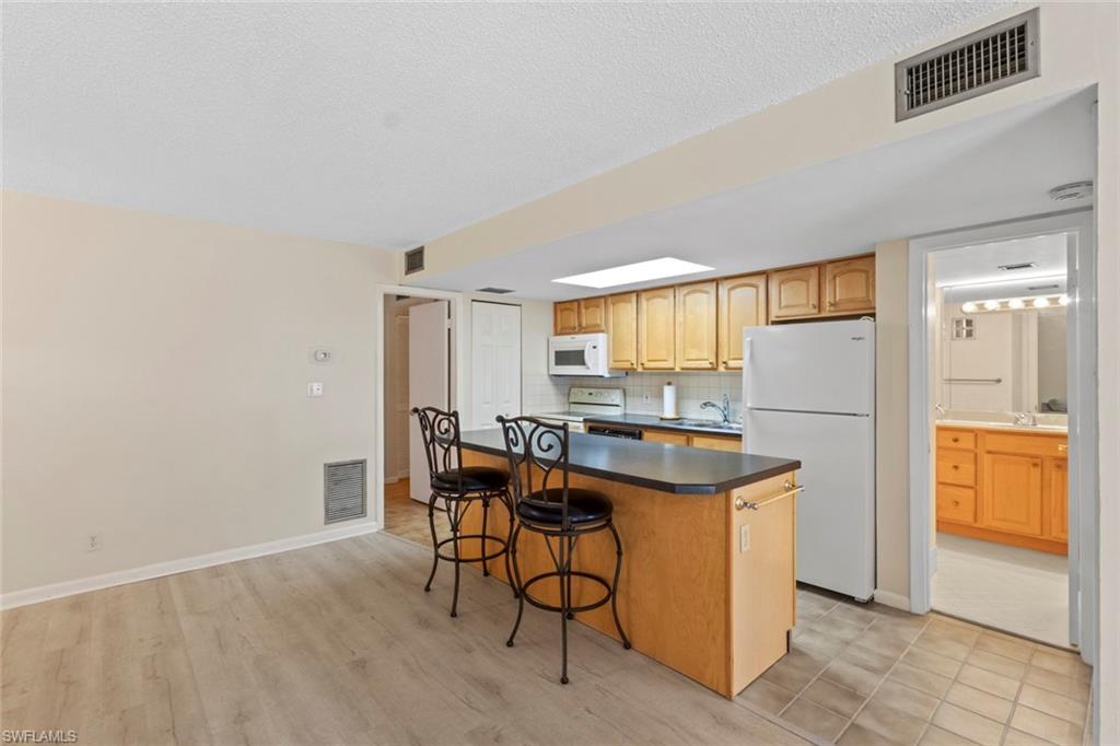 248 Palm Drive, Unit 5 Naples, FL 34112 - Photo 11 of 37 a view of a kitchen with furniture and window