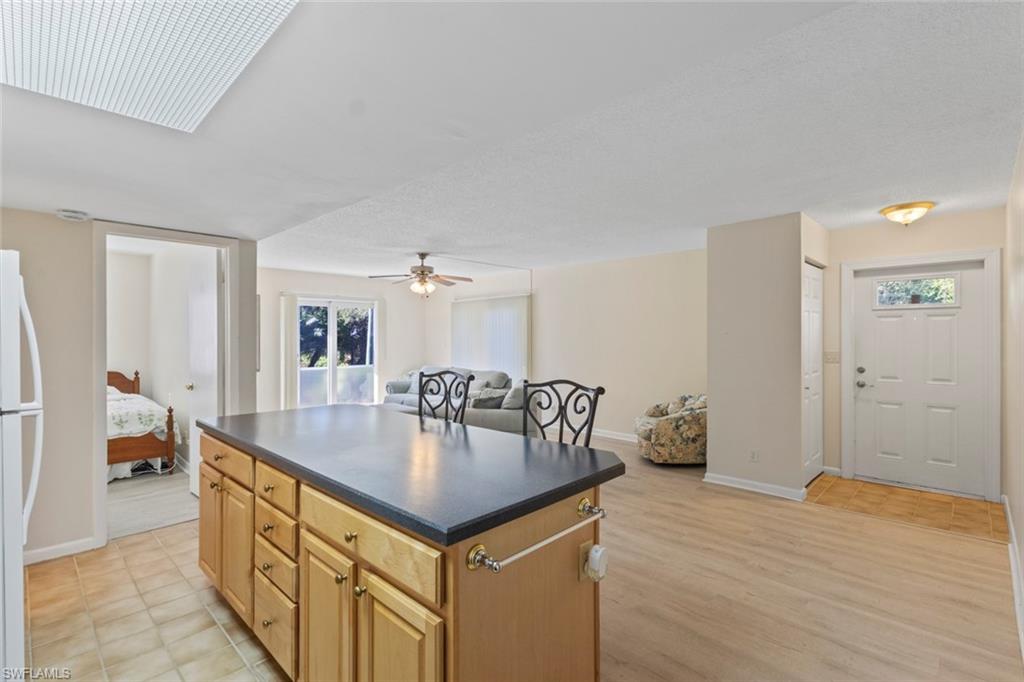 248 Palm Drive, Unit 5 Naples, FL 34112 - Photo 13 of 37 a hallway with table and couch