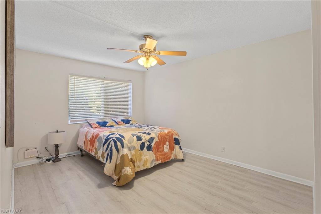 248 Palm Drive, Unit 5 Naples, FL 34112 - Photo 14 of 37 a bedroom with a bed and a window