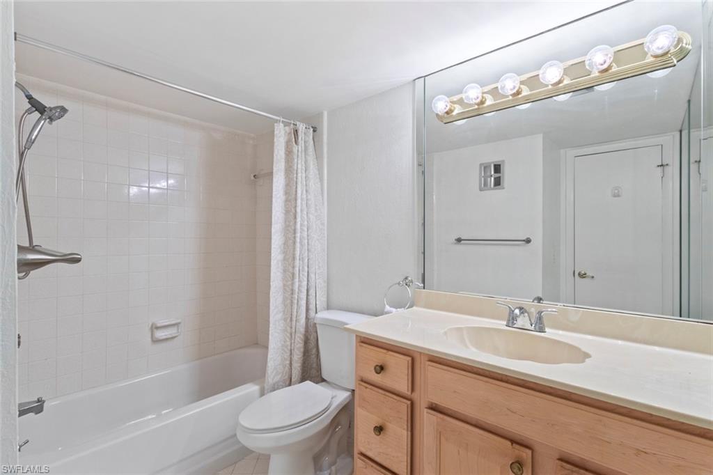 248 Palm Drive, Unit 5 Naples, FL 34112 - Photo 17 of 37 a bathroom with a granite countertop sink a toilet and shower