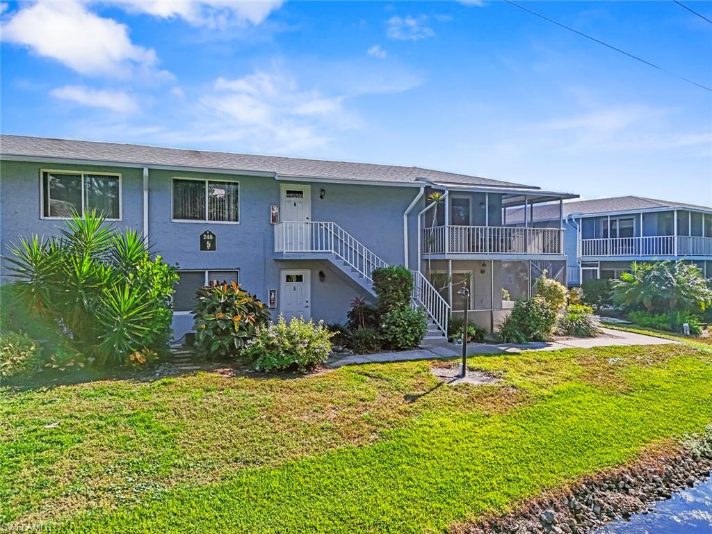 248 Palm Drive, Unit 5 Naples, FL 34112 - Photo 2 of 37 a view of a house with a yard