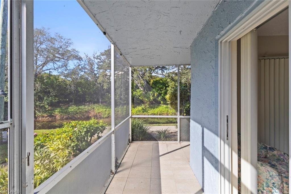 248 Palm Drive, Unit 5 Naples, FL 34112 - Photo 3 of 37 a view of a glass door with a yard from a window