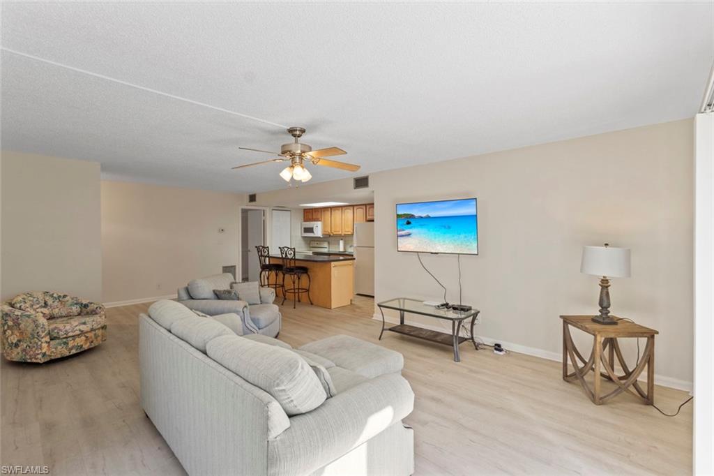 248 Palm Drive, Unit 5 Naples, FL 34112 - Photo 5 of 37 a living room with furniture and a lamp