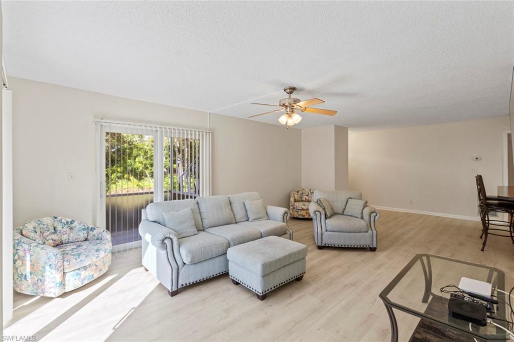 248 Palm Drive, Unit 5 Naples, FL 34112 - Photo 6 of 37 a living room with furniture and a large window