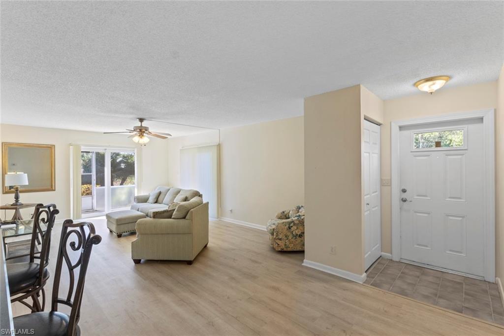 248 Palm Drive, Unit 5 Naples, FL 34112 - Photo 7 of 37 a living room with furniture and a wooden floor