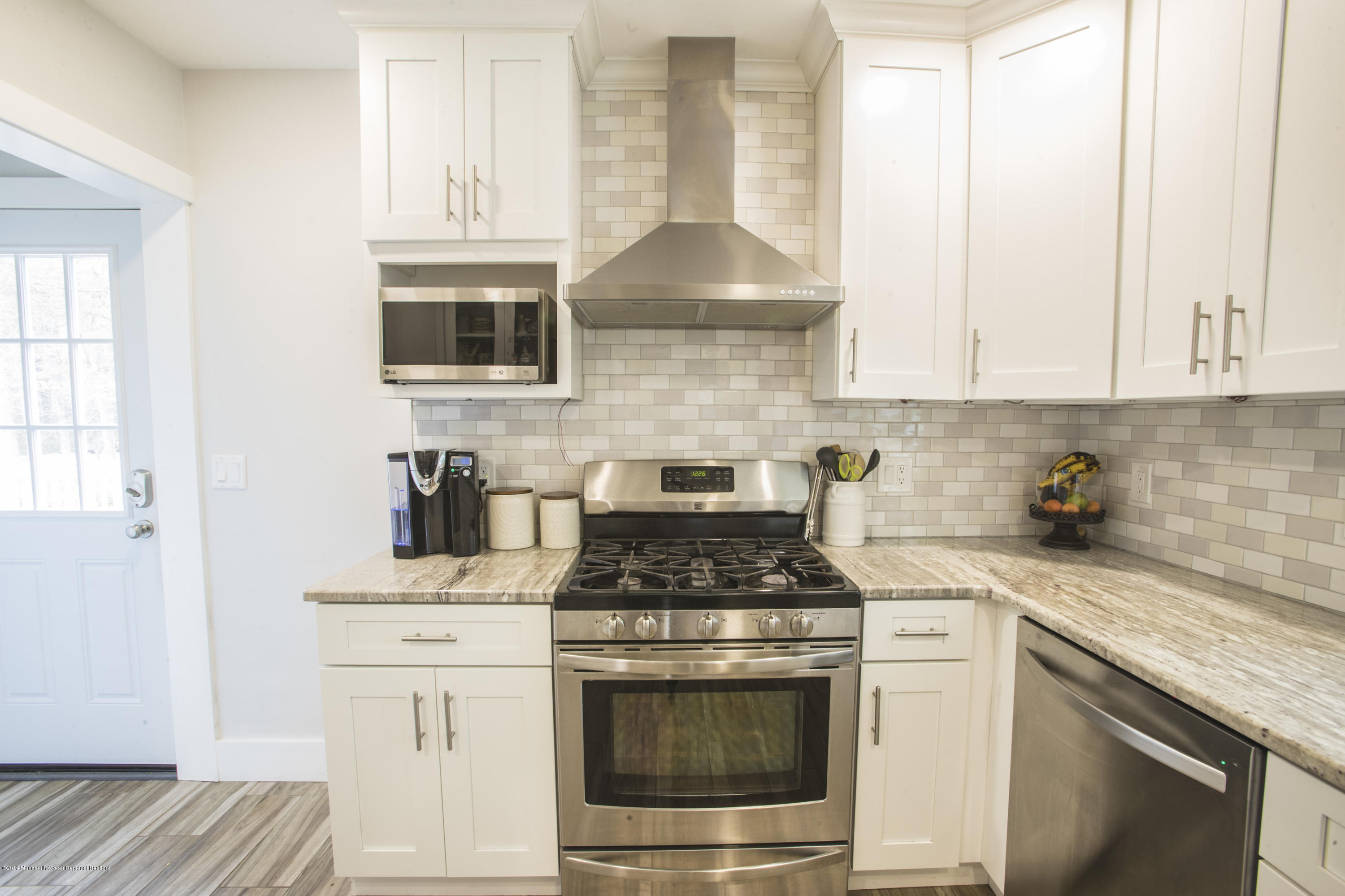 204 Leesville Road Jackson, NJ 08527 - Photo 11 of 49 a kitchen with granite countertop white cabinets and white appliances