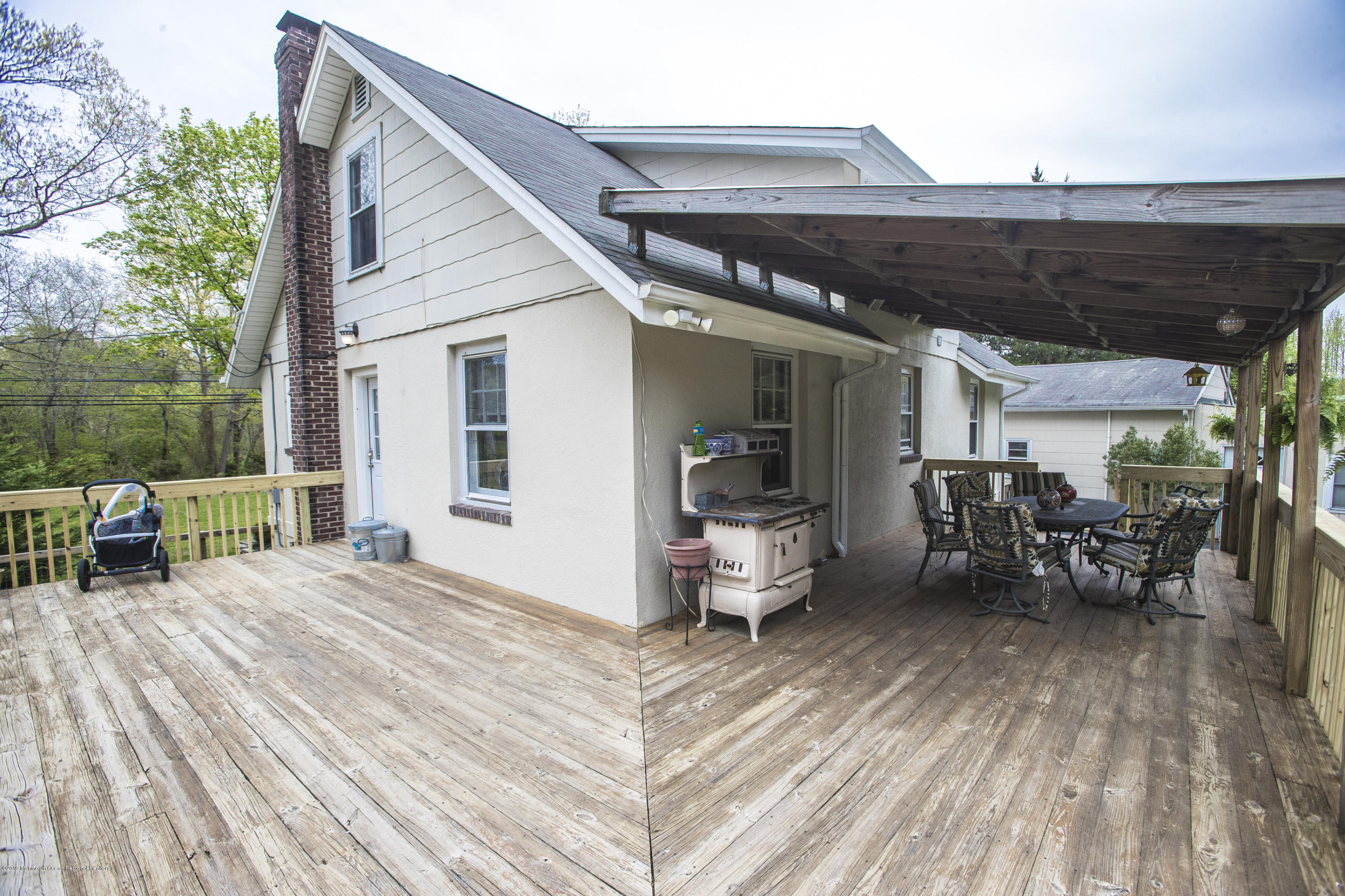 204 Leesville Road Jackson, NJ 08527 - Photo 23 of 49 a view of a patio with table and chairs with wooden floor and fence