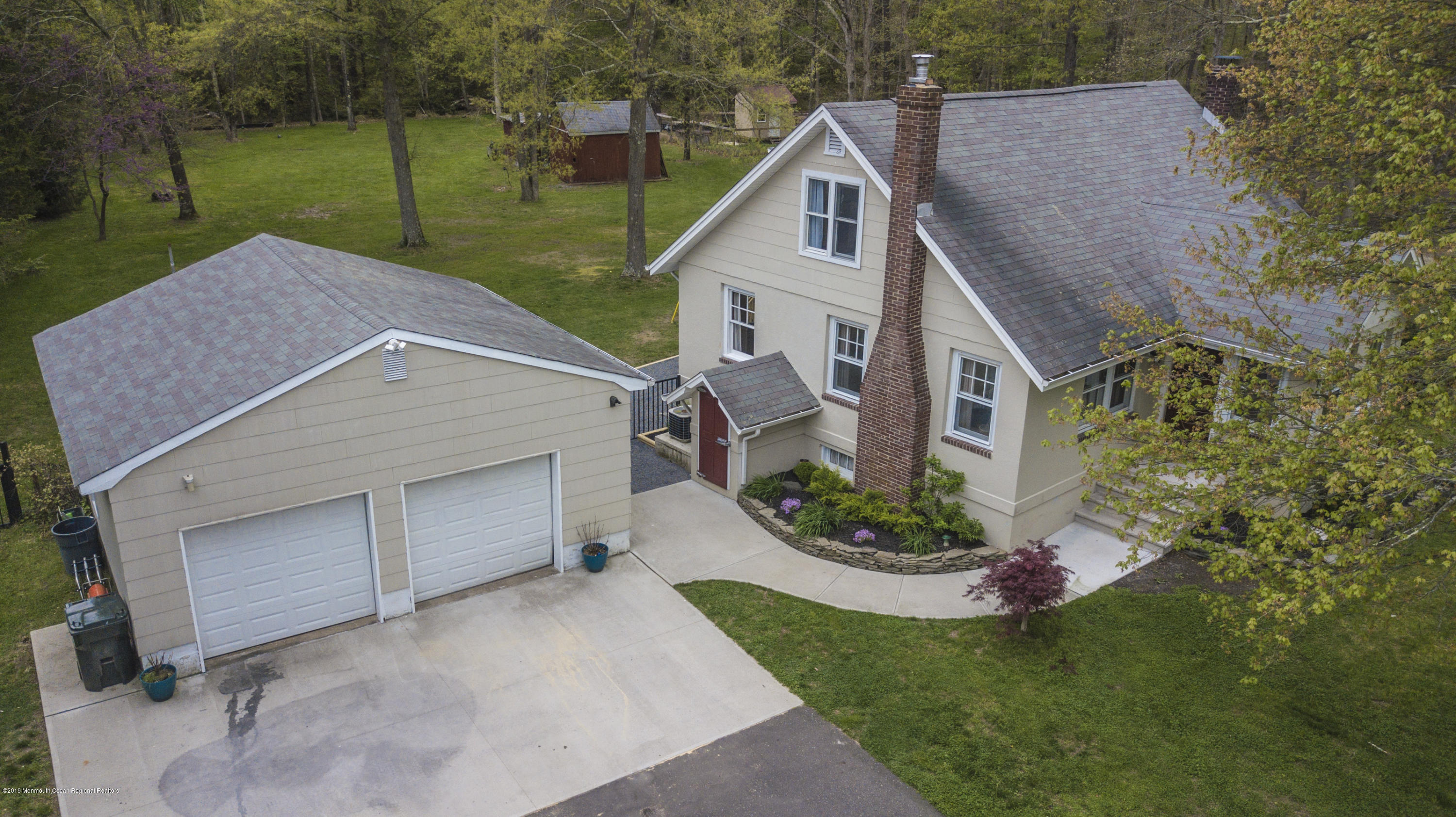 204 Leesville Road Jackson, NJ 08527 - Photo 38 of 49 a aerial view of a house with a yard table and chairs
