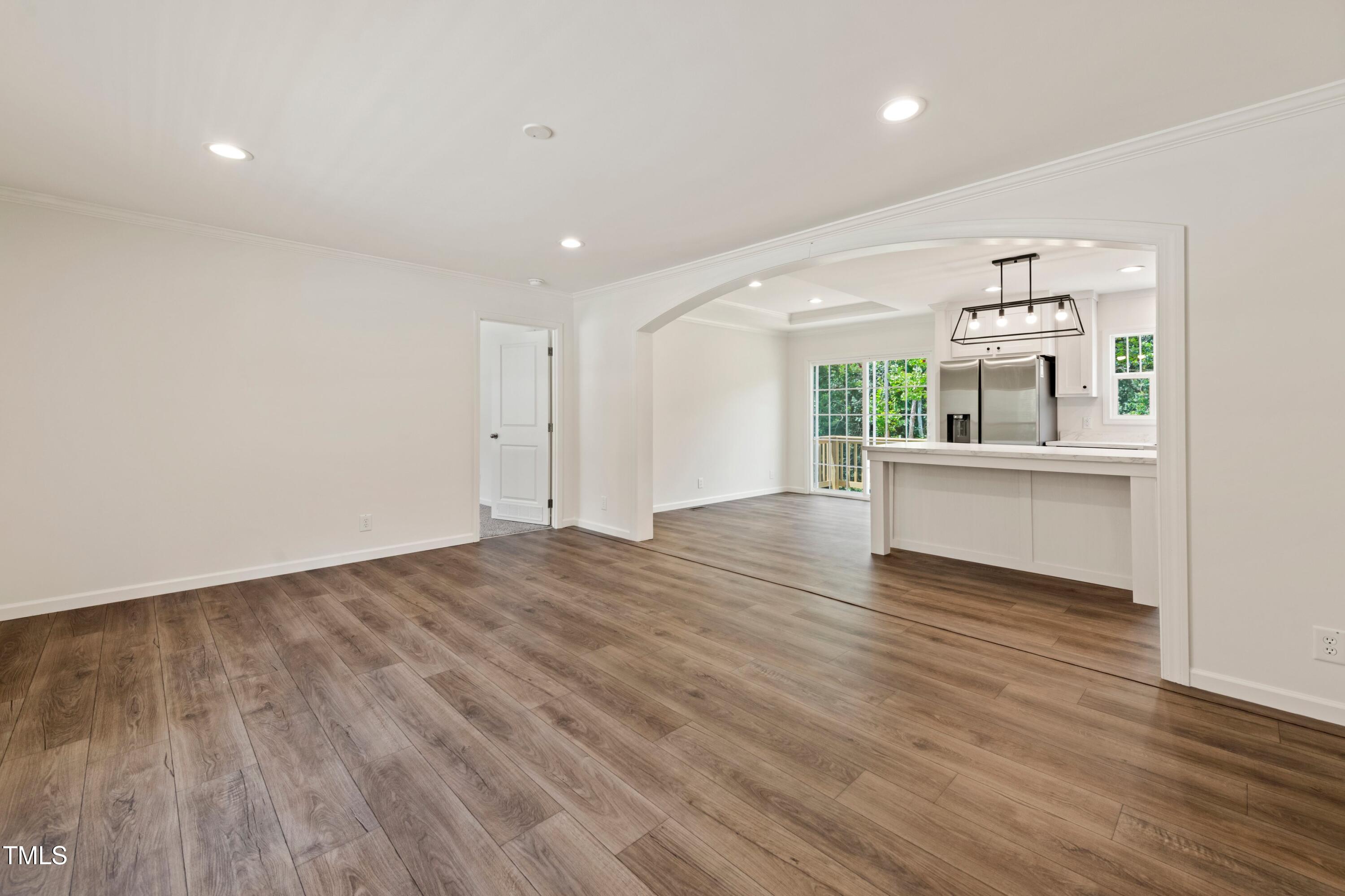 985 John Oakley Road Prospect Hill, NC 27314 - Photo 6 of 23 an empty room with wooden floor and windows