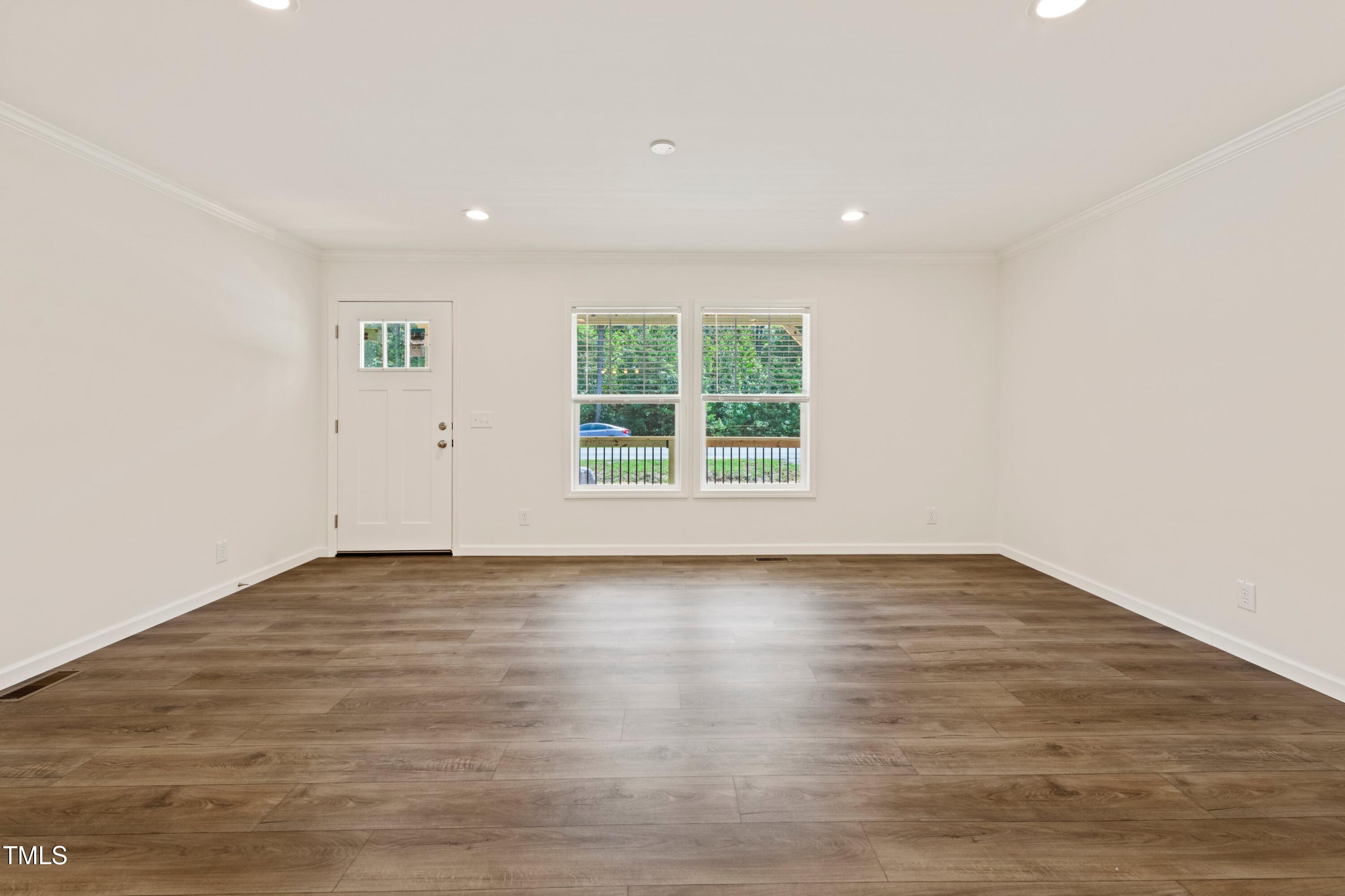 985 John Oakley Road Prospect Hill, NC 27314 - Photo 7 of 23 an empty room with wooden floor and windows