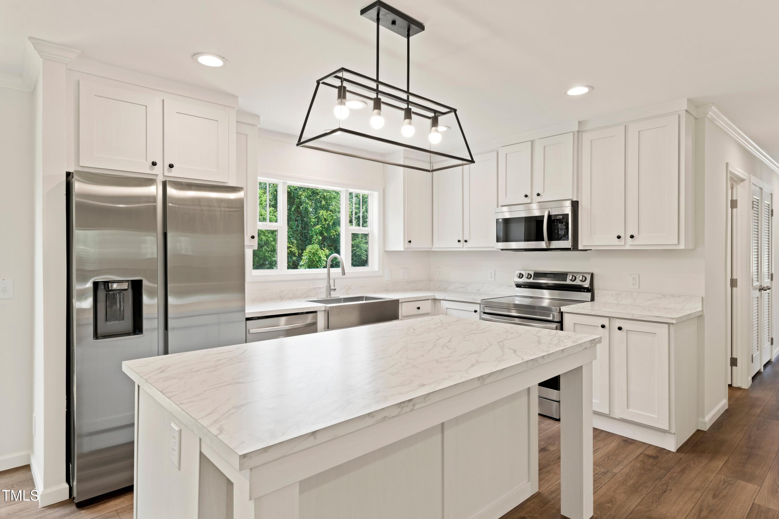 985 John Oakley Road Prospect Hill, NC 27314 - Photo 8 of 23 a kitchen with kitchen island a counter appliances and cabinets