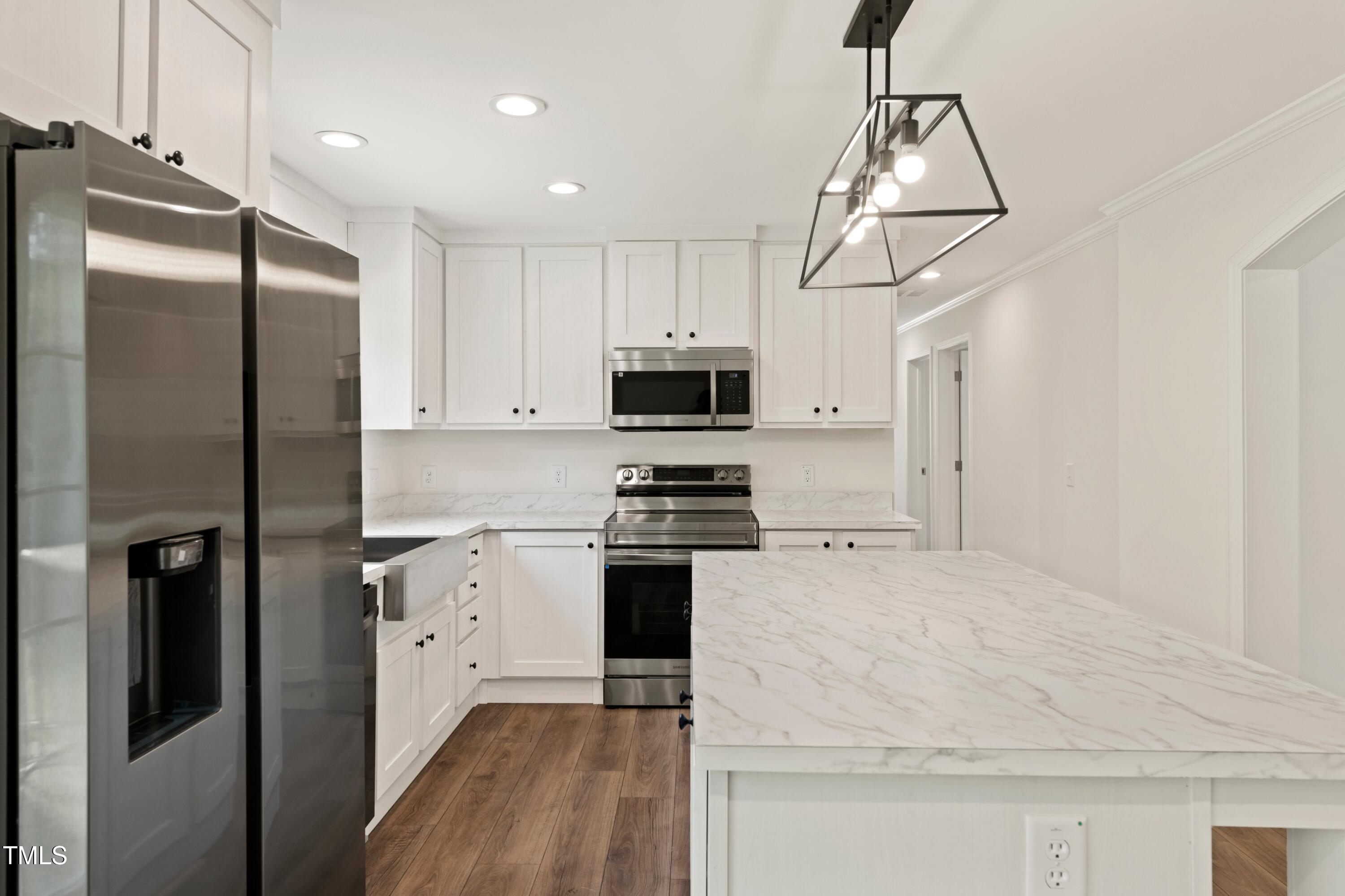 985 John Oakley Road Prospect Hill, NC 27314 - Photo 9 of 23 a kitchen with stainless steel appliances granite countertop a refrigerator a stove a sink and a microwave