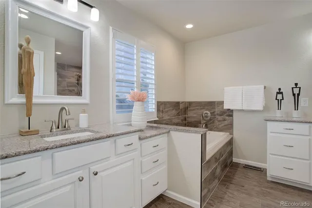a kitchen with granite countertop a sink and a stove