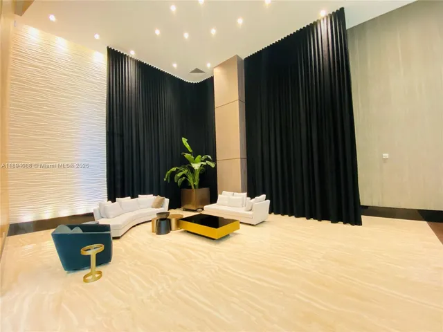 a bedroom with a bed a couch and potted plant