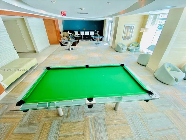 a blue couch sitting in a living room with a tv