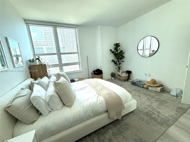 a bedroom with bed and a window