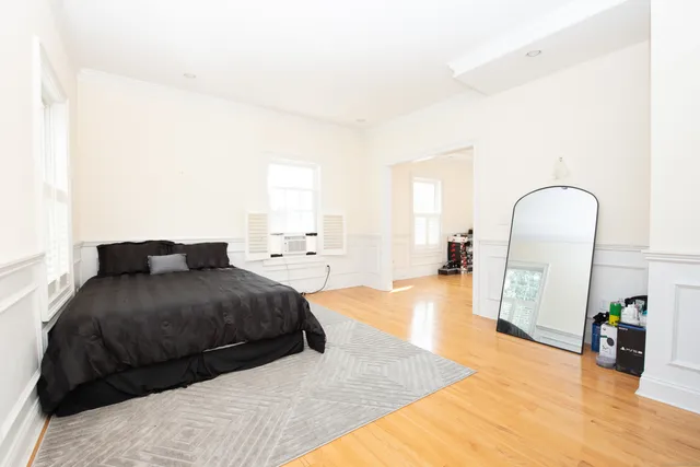 a bedroom with a large bed and a dresser