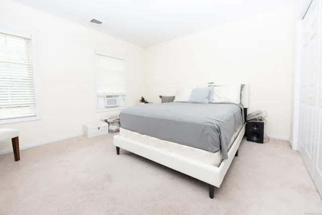 a bedroom with a bed and a chair