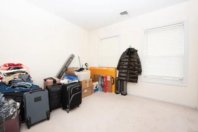 a picture of floor with a white wall and a painting