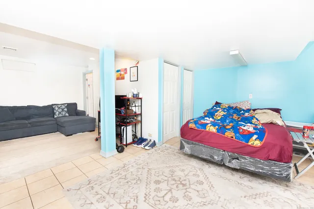 a living room with a baby crib furniture and a couch