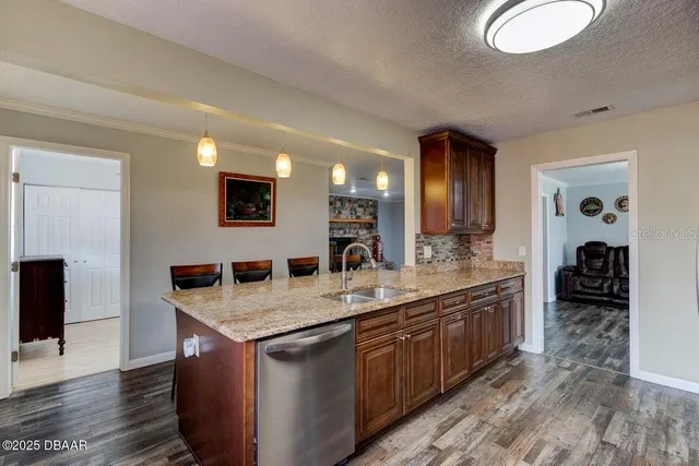 a bathroom with a granite countertop sink a mirror and shower