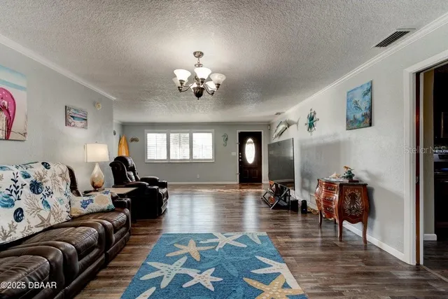 a living room with furniture two couches and a potted plant on table