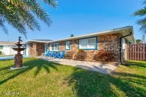 a view of a house with backyard and porch