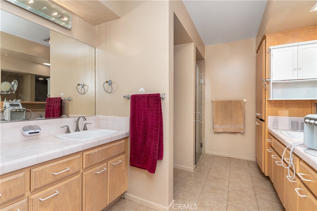 4967 Chapala Drive Riverside, CA 92507 - Photo 22 of 34 a spacious bathroom with a double vanity sink a mirror and a shower