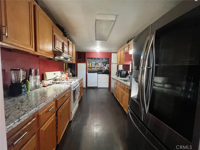 a large kitchen with stainless steel appliances granite countertop lots of counter top space