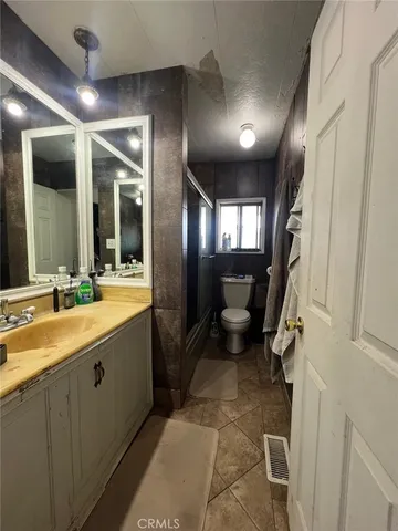 a spacious bathroom with a double vanity sink a mirror and a shower