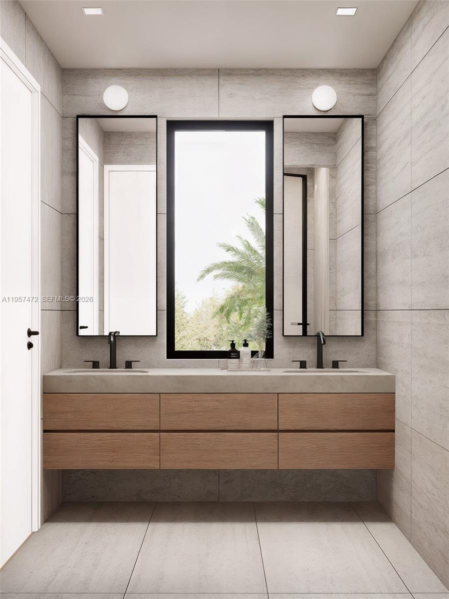 1017 Southwest 13th Court Miami, FL 33135 - Photo 7 of 8 a bathroom with a double vanity sink a mirror and a bathtub