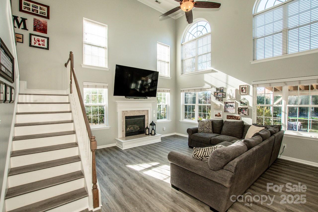 182 Harris Farm Road Mooresville, NC 28115 - Photo 14 of 44 a living room with furniture a fireplace and a flat screen tv
