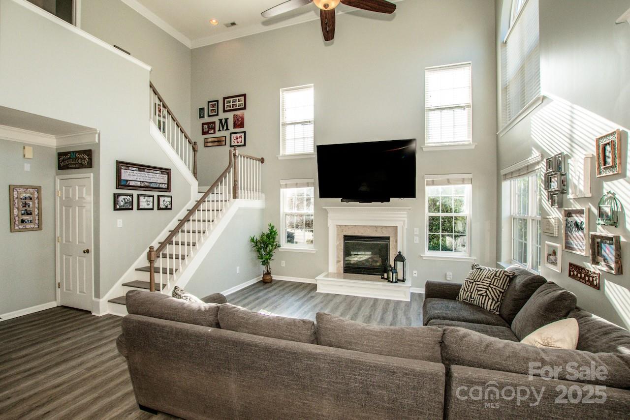 182 Harris Farm Road Mooresville, NC 28115 - Photo 15 of 44 a living room with furniture a flat screen tv and a fireplace