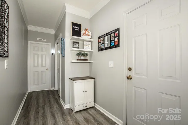a view of a hallway with bathroom and front door