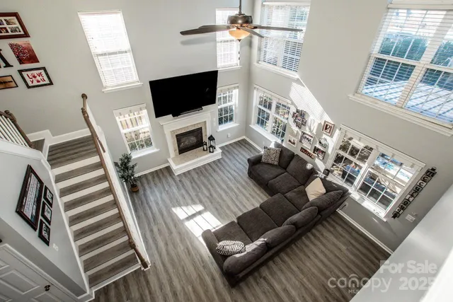 a living room with furniture a flat screen tv and a fireplace